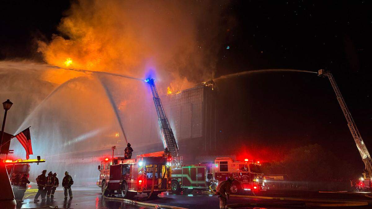 Flames could be seen erupting from the upper floor and roof area of Templeton Feed & Grain early July 5, 2025, as firefighters attempted to save the building.&nbsp;