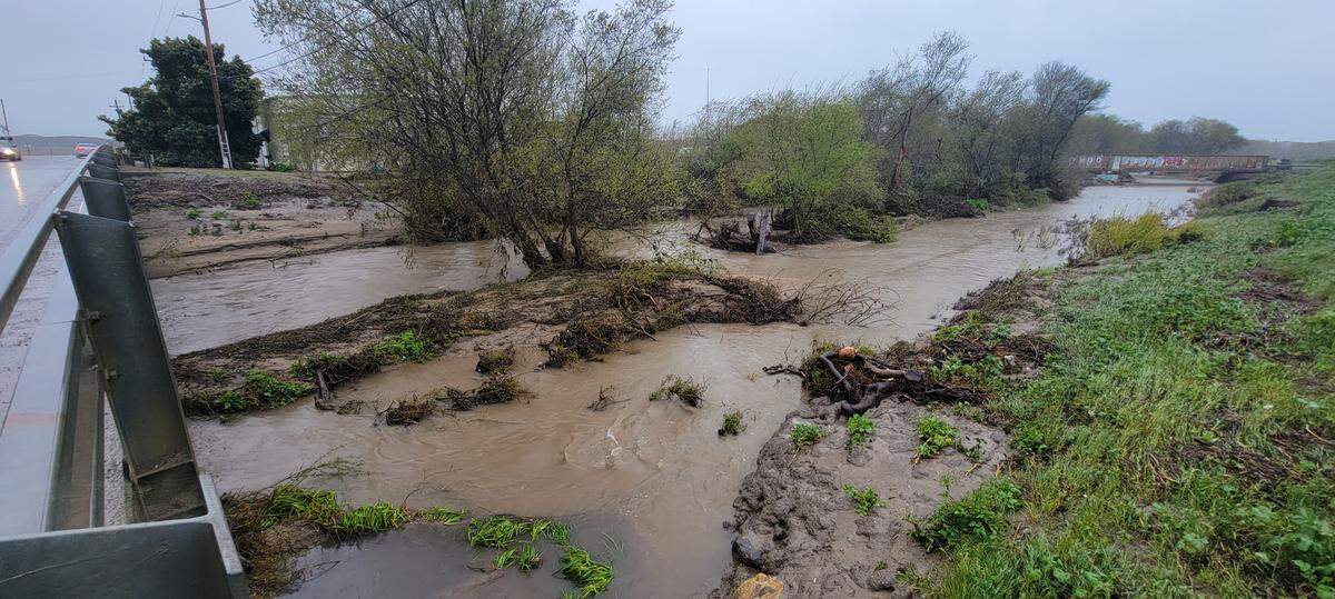 Arroyo Grande Creek flows under the 22nd Street Bridge in Oceano as a new storm hit the county on March 14, 2023.