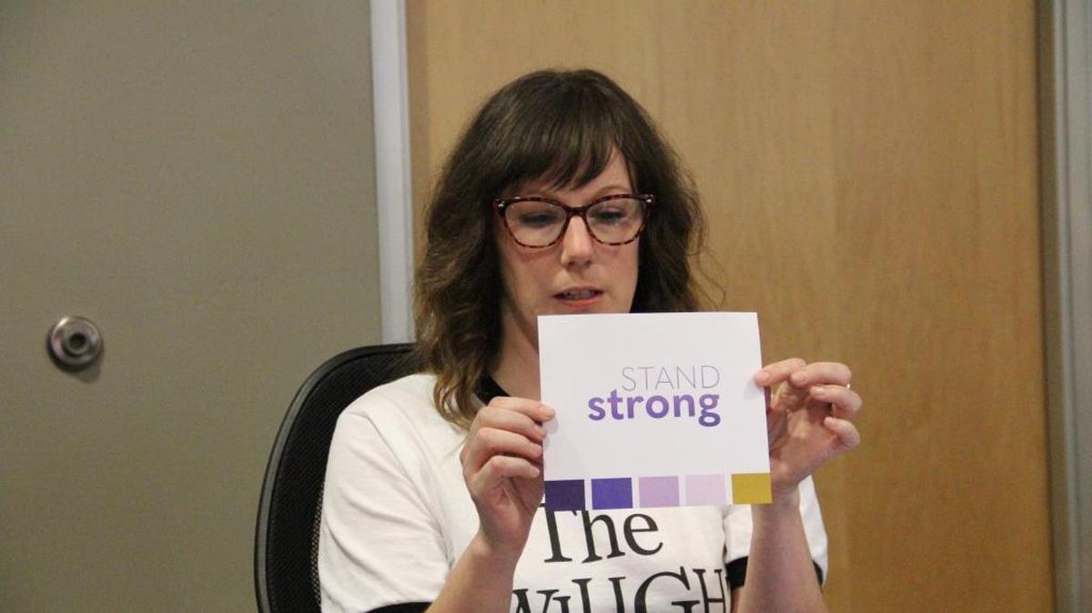 Verdin art director Megan Condict holds up a potential logo and color palette for the new brand.