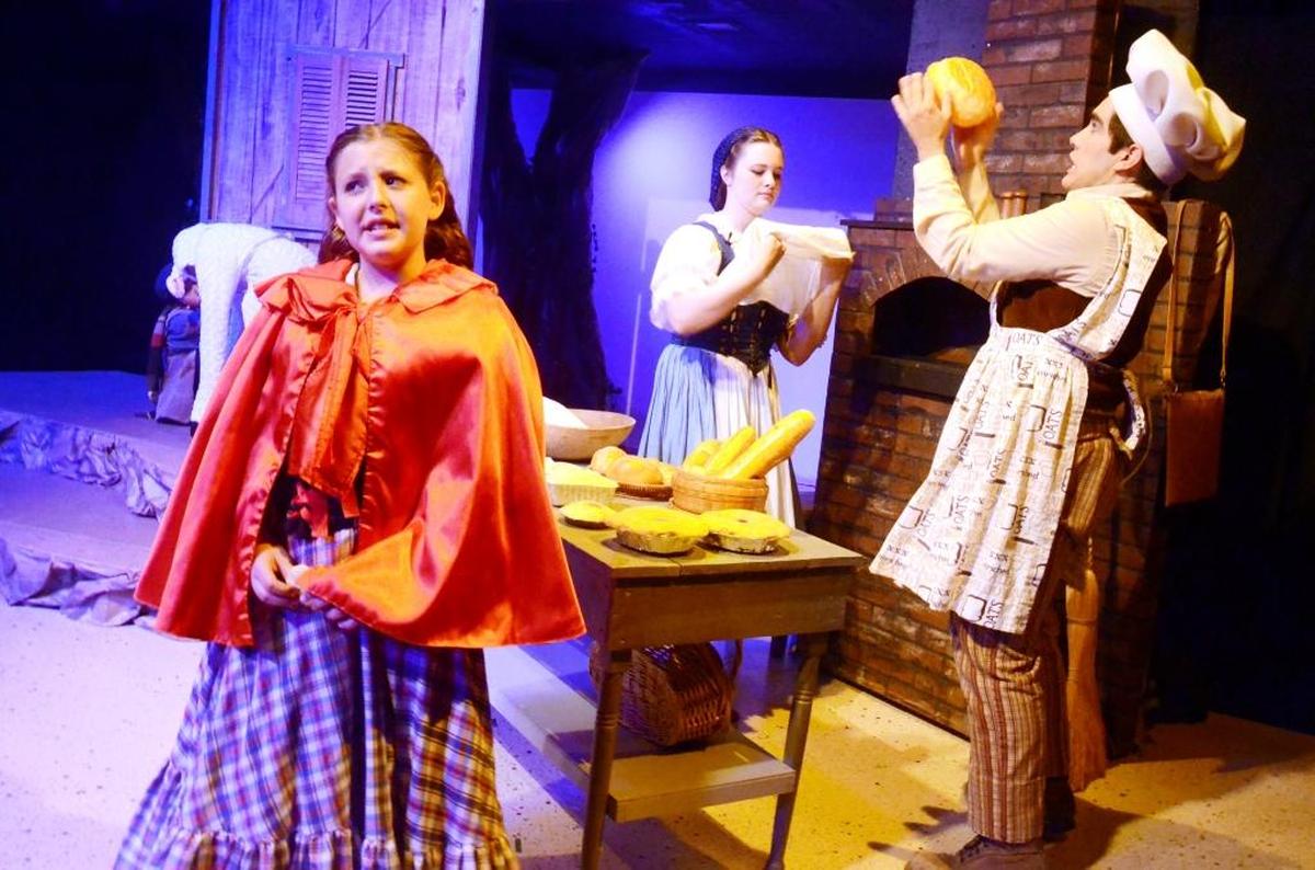 Little Red (Serafina Regusci) considers her options before traveling with the Baker (Jed Authier) the Baker’s Wife (Alyssa Mickey) and Milky White (Addisyn Tejada) in “Into the Woods, Jr.,” playing at San Luis Obispo Repertory Theatre.