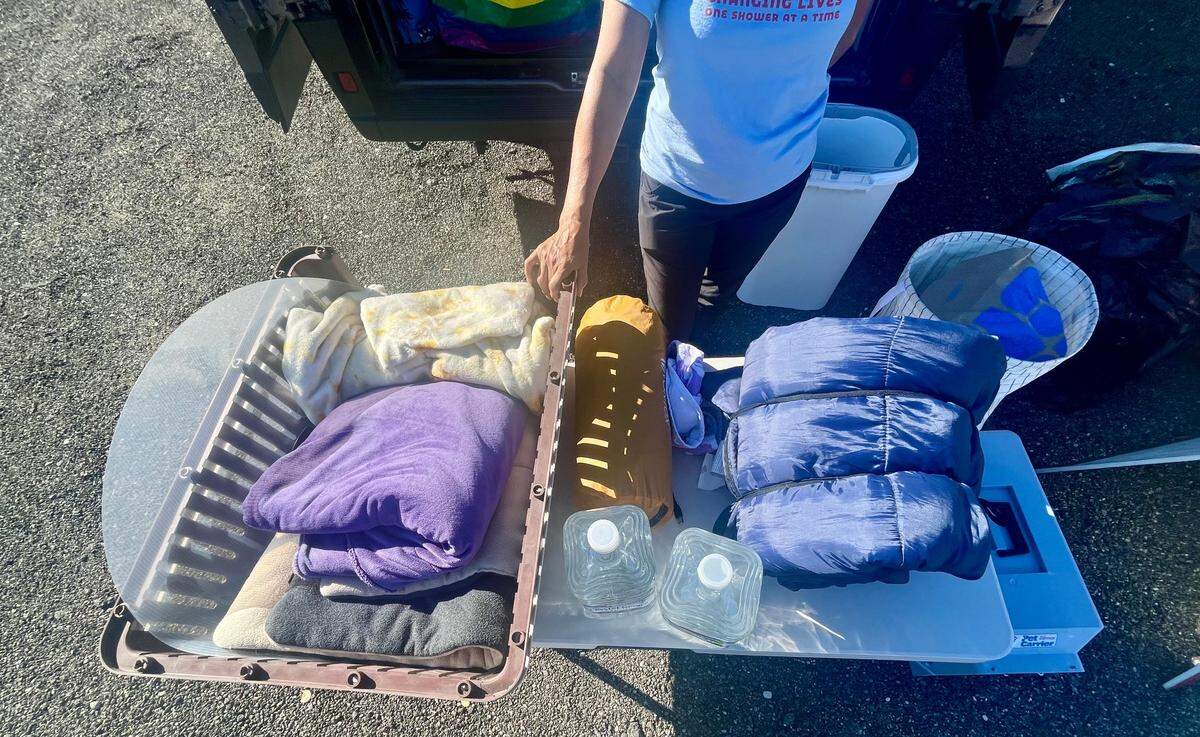 Del Owen, of San Luis Obispo, gathers donations for people displaced by the devastating fires raging in Southern California in January 2025. Collected items include water, dog crates, blankets and sleeping bags.
