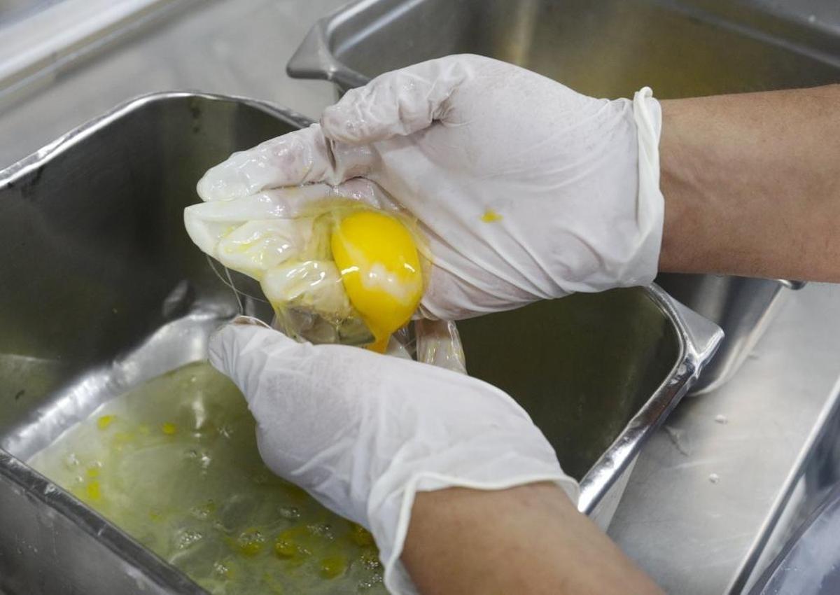 Inmate Javier Davalos separates egg yolks and whites for a flourless chocolate cake.