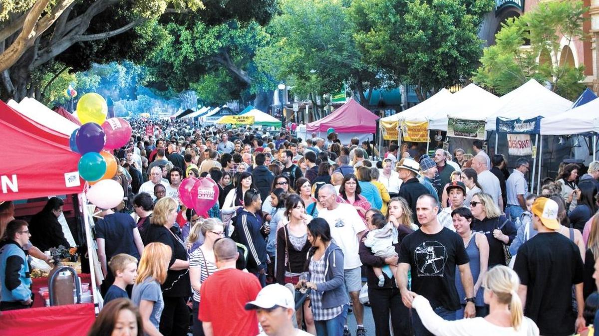 A busy Farmers Market packs Higuera Street in downtown San Luis Obispo on a warm summer evening.