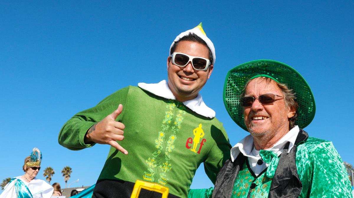 Josiah Johnstone, left, and Steve Lindsmeir wore green for the 39th annual Carlin Soule Memorial Polar Bear Dip was held at noon January 1, 2019 at the Cayucos Pier.
