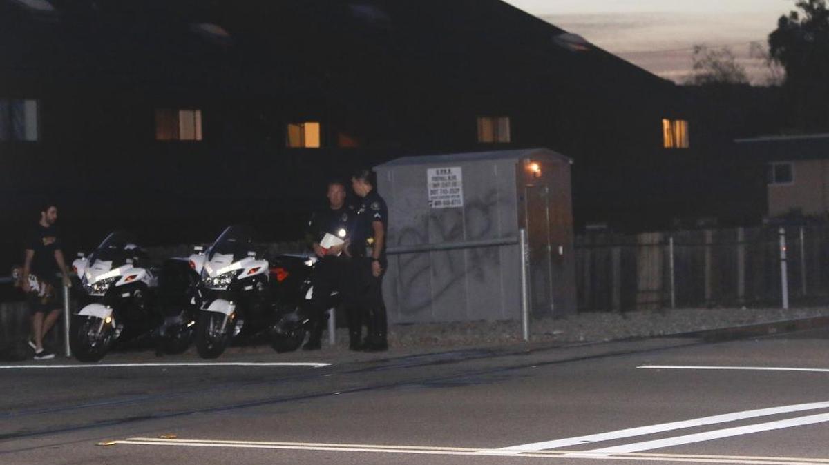 San Luis Obispo police officers at the railroad tracks near the corner of Foothill and California boulevards, where a man was struck by an Amtrak train on Tuesday evening.