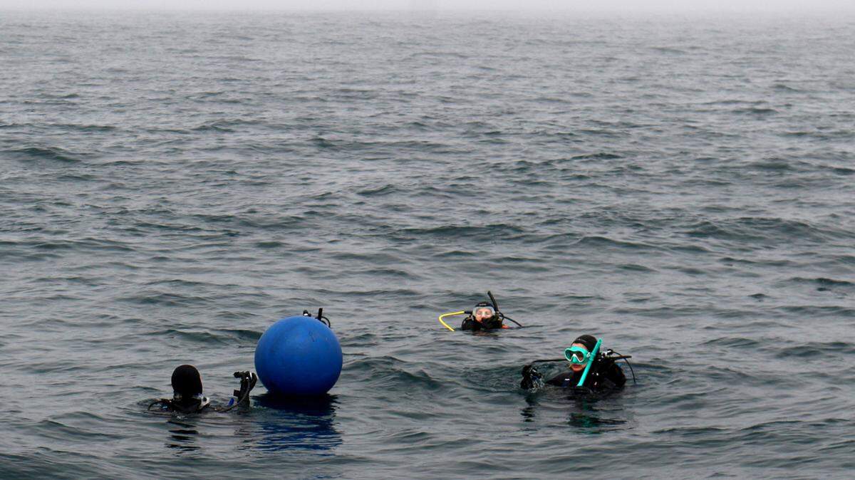 NOAA divers prepare to dive and check out an underwater sound recorder they placed in the proposed Chumash Heritage National Marine Sanctuary on July 12, 2023.