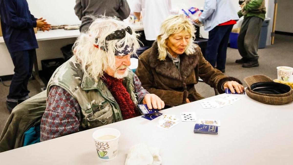Jon Akeman and Linda McClelland play cards at the 5 Cities Homeless Coalition Warming Center at the department of Social Services in Arroyo Grande in January.