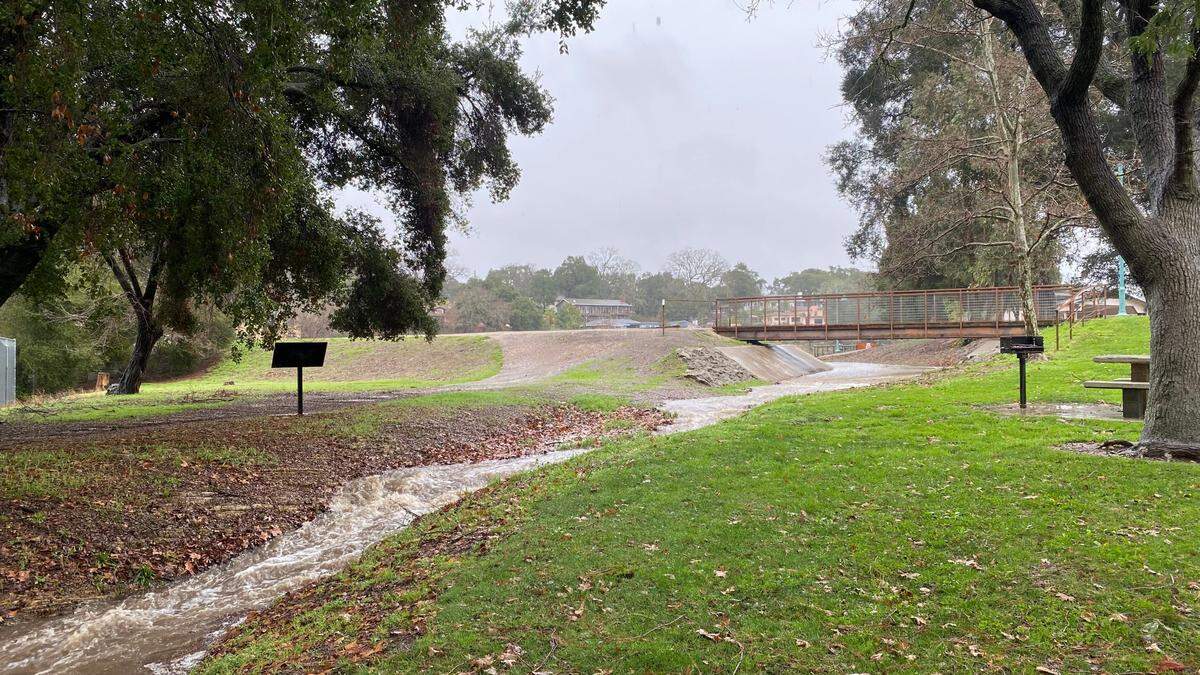 Atascadero Lake overflows into its spillway on Jan. 9, 2023.