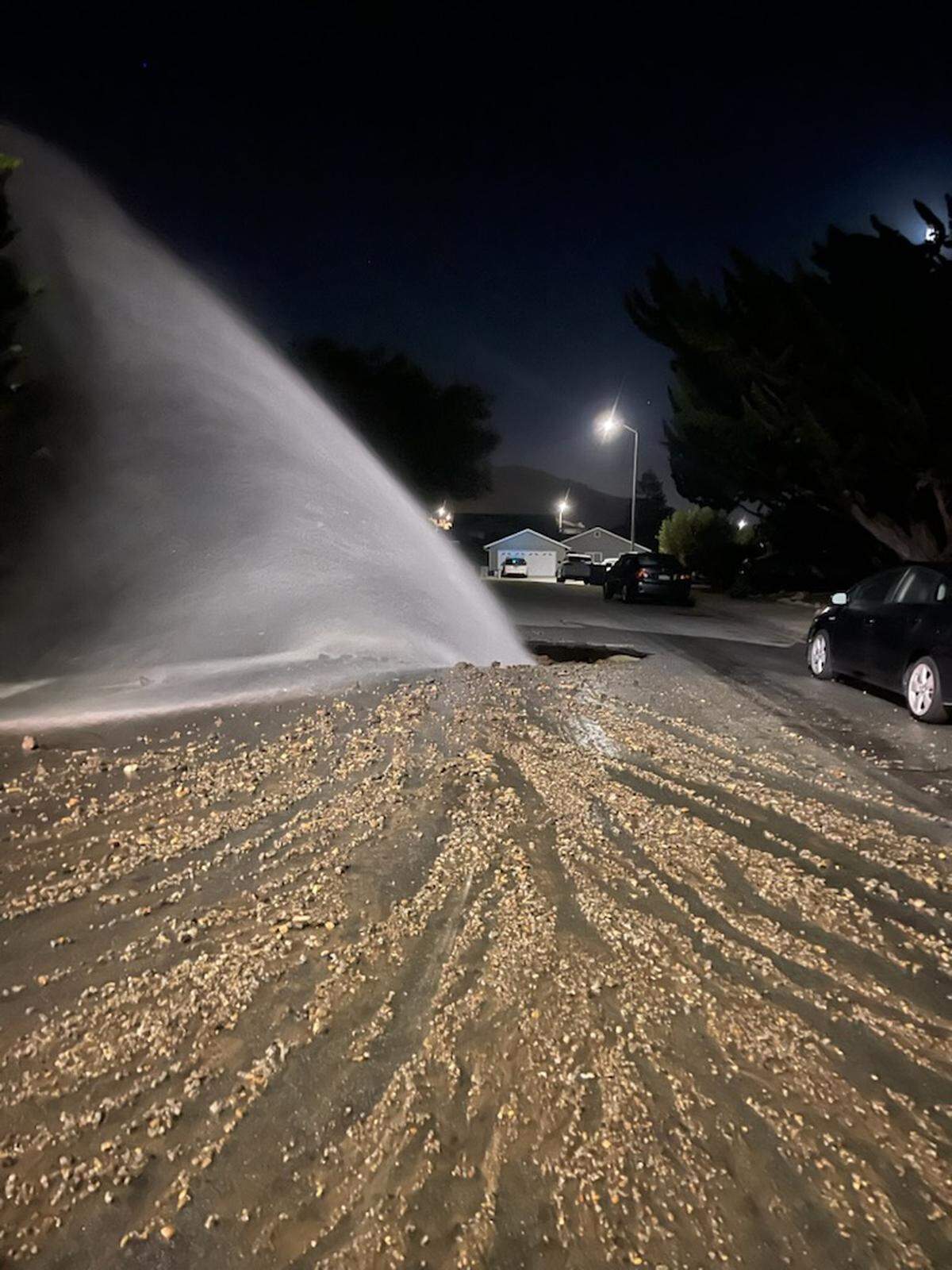 A water main break in the Calle Lupita neighborhood of San Luis Obispo sent chunks of asphalt and debris flying and created a large geyser on May 21, 2025. 