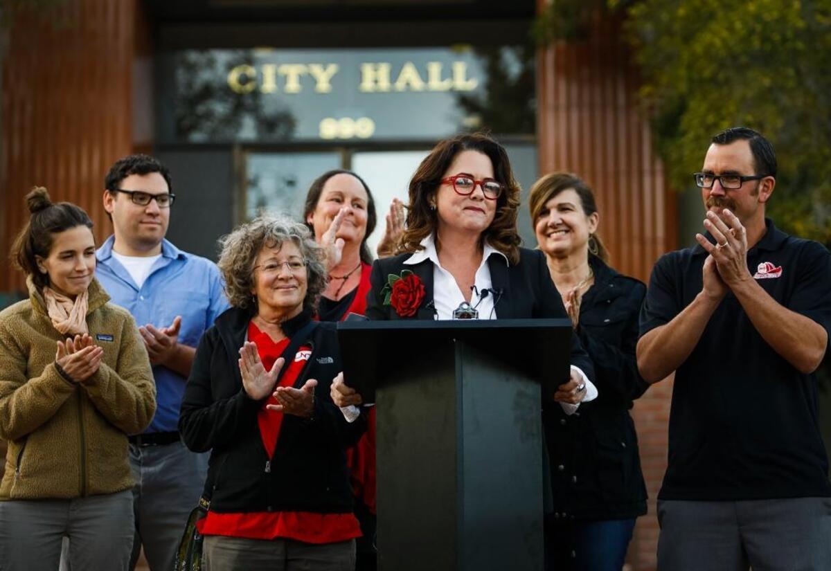 San Luis Obispo Mayor-elect Heidi Harmon, surrounded by election staff and supporters, talks of inclusiveness and more during an address in front of City Hall soon after winning the election by 46 votes.
