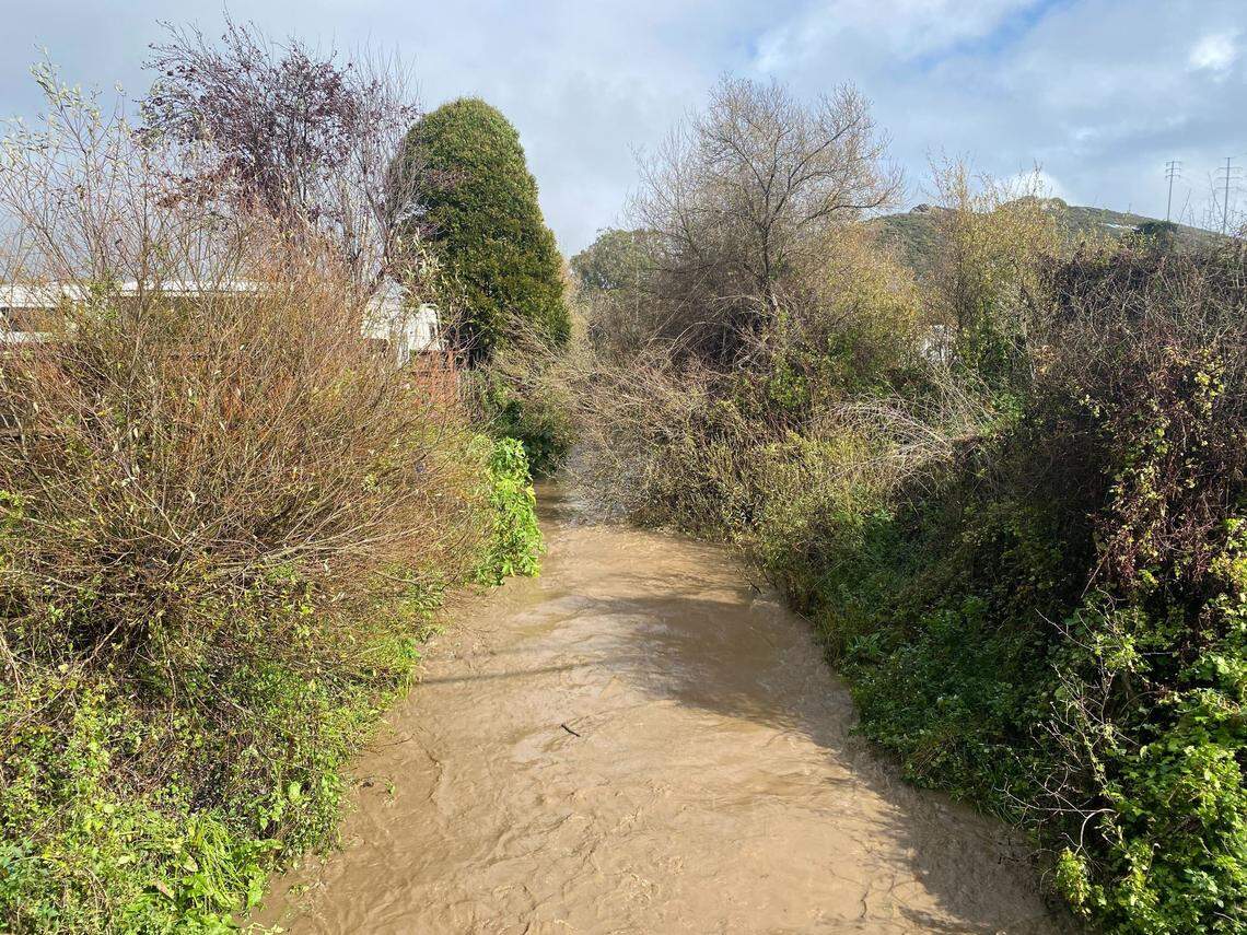 A swollen Morro Creek near Main Street in Morro Bay is pictured on Feb. 13, 2025, as an atmospheric river storm swept across San Luis Obispo County. 