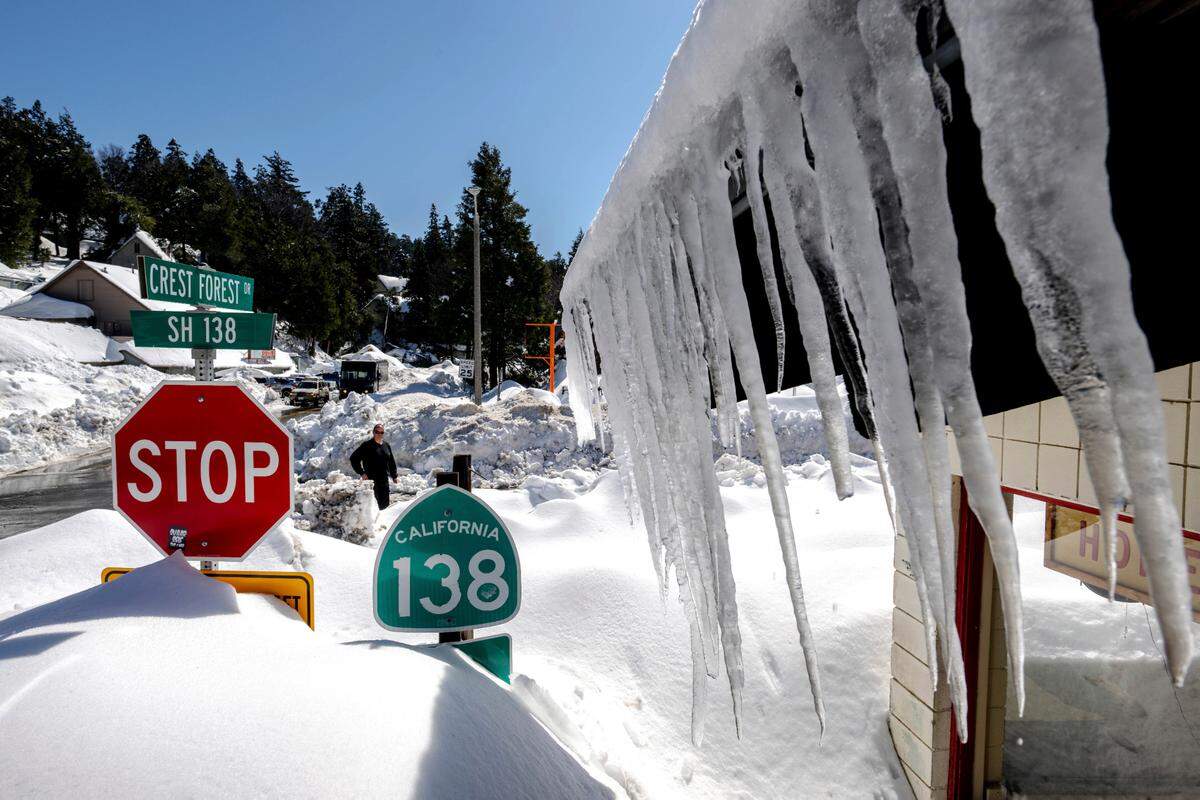 Snowfall surrounds businesses in Crestline, Calif., Friday, March 3, 2023, following a huge snowfall that buried homes and businesses.