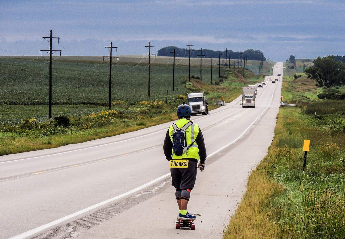 Jack Smith rides on an electric skateboard across America, a trip he completed in September. The board is now part of the Smithsonian.