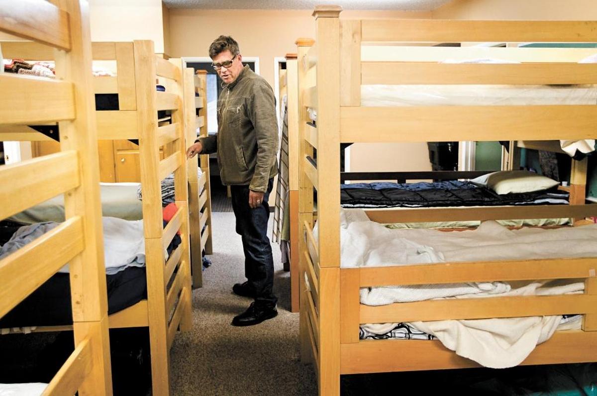 El Camino Homeless Organization’s former executive director Bill Watt gives a tour through the sleeping area at the shelter in a photo from 2012.