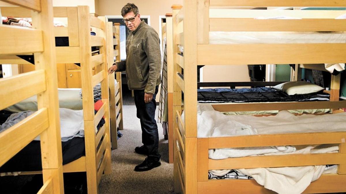 El Camino Homeless Organization’s former executive director Bill Watt gives a tour through the sleeping area at the shelter in a photo from 2012.