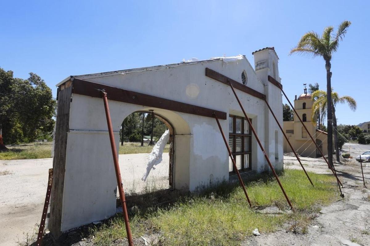A lone facade from the original Motel Inn is propped up by supports on Monterey Street in San Luis Obispo.