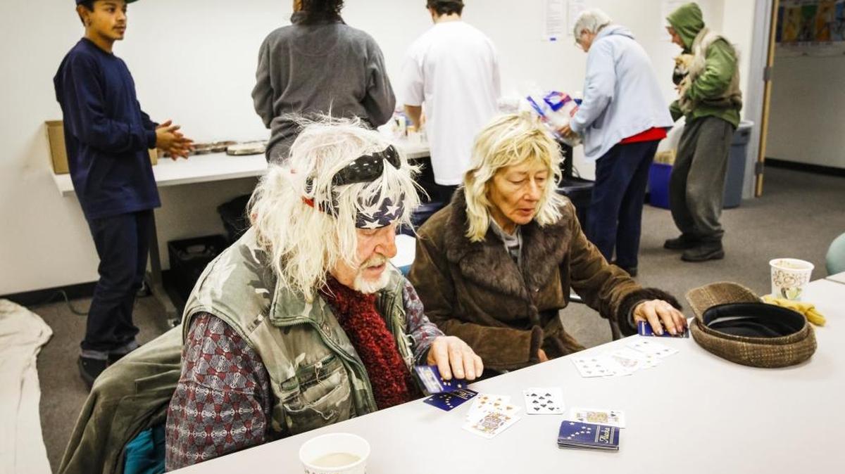 Jon Akeman and Linda Mcclelland play cards at the 5 Cities Homeless Coalition Warming Center at the department of Social Services in Arroyo Grande on Jan. 6.