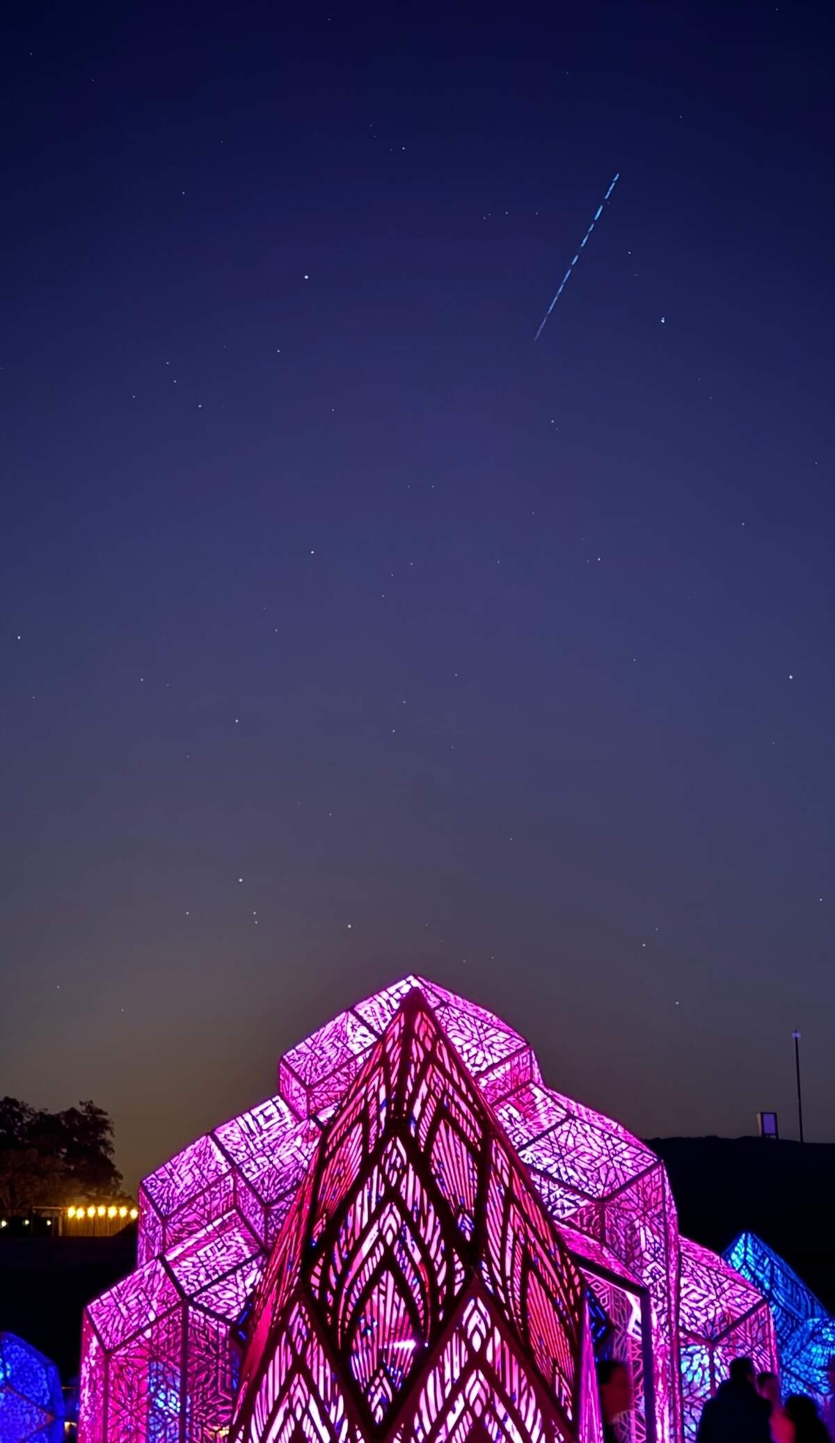 A string of satellites pass bay in the night sky over the DIMENSIONS exhibit at Sensorio in Paso Robles on May 23, 2024.