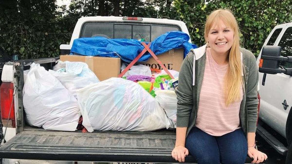 Shelby Green sits in the back of a truck loaded with supplies meant for victims of the Northern California wildfires.