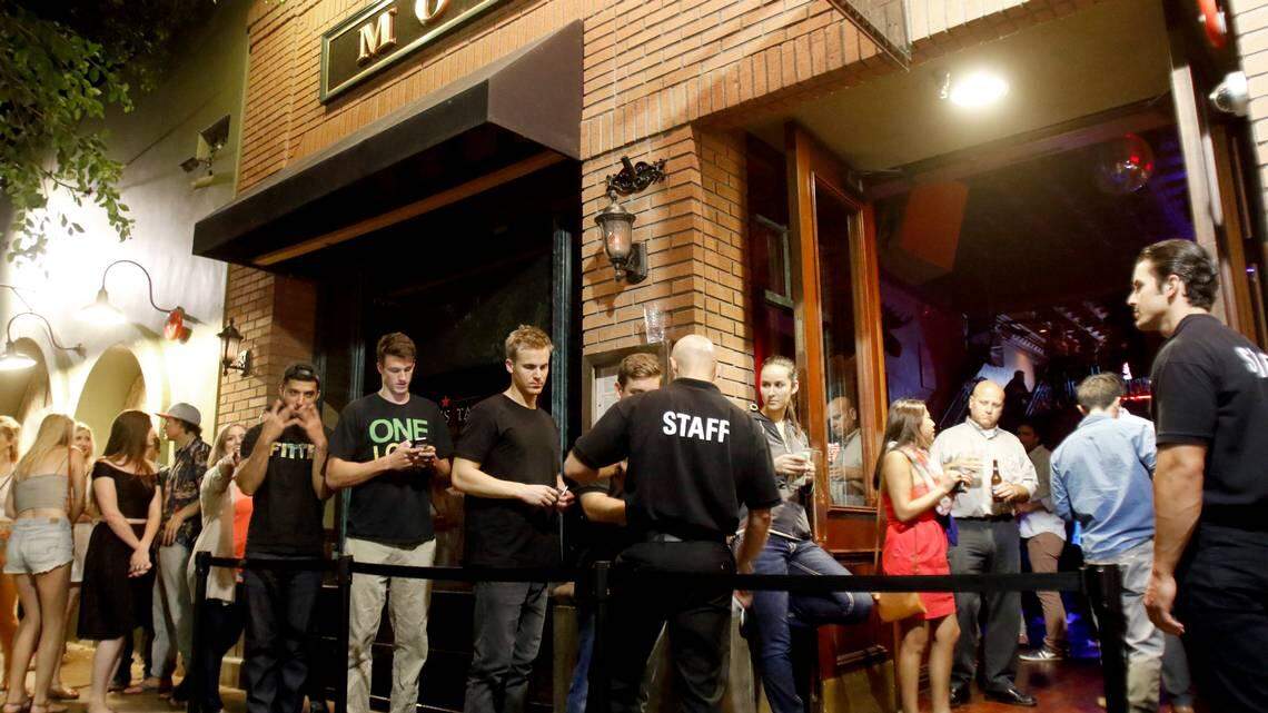 Patrons line up to get into MoTav in downtown San Luis Obispo. Coronavirus concerns have led to Gov. Gavin Newsom asking for bars to shut down and restaurants to limit capacity.