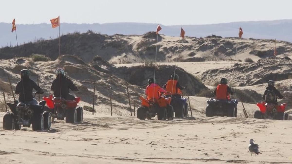 A group of riders leaves Sun Buggy Fun Rentals for a morning on the Oceano Dunes in 2014. The shop is one of four rental businesses that can reopen as part of the park’s final COVID-19 reopening phase.