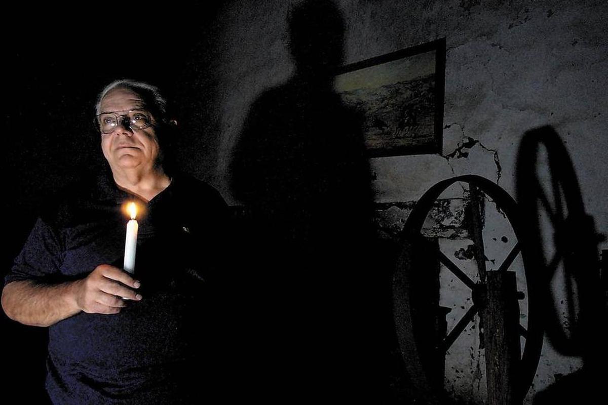 The late Wally Ohles in 2003 stands inside the room at Misssion San Miguel where it's thought the murders occurred.