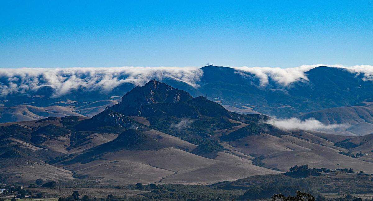 Santa Lucia winds from the northeast gently sweep stratus clouds over the coastal mountains toward San Luis Obispo.
