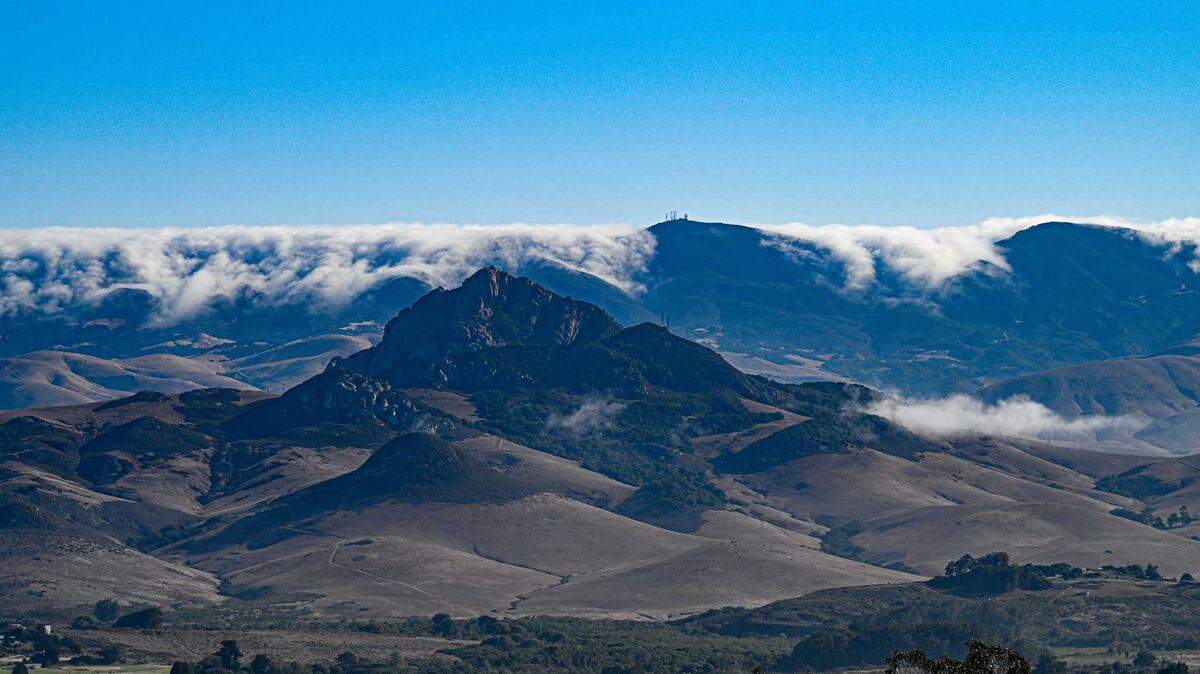 Santa Lucia winds from the northeast gently sweep stratus clouds over the coastal mountains toward San Luis Obispo.