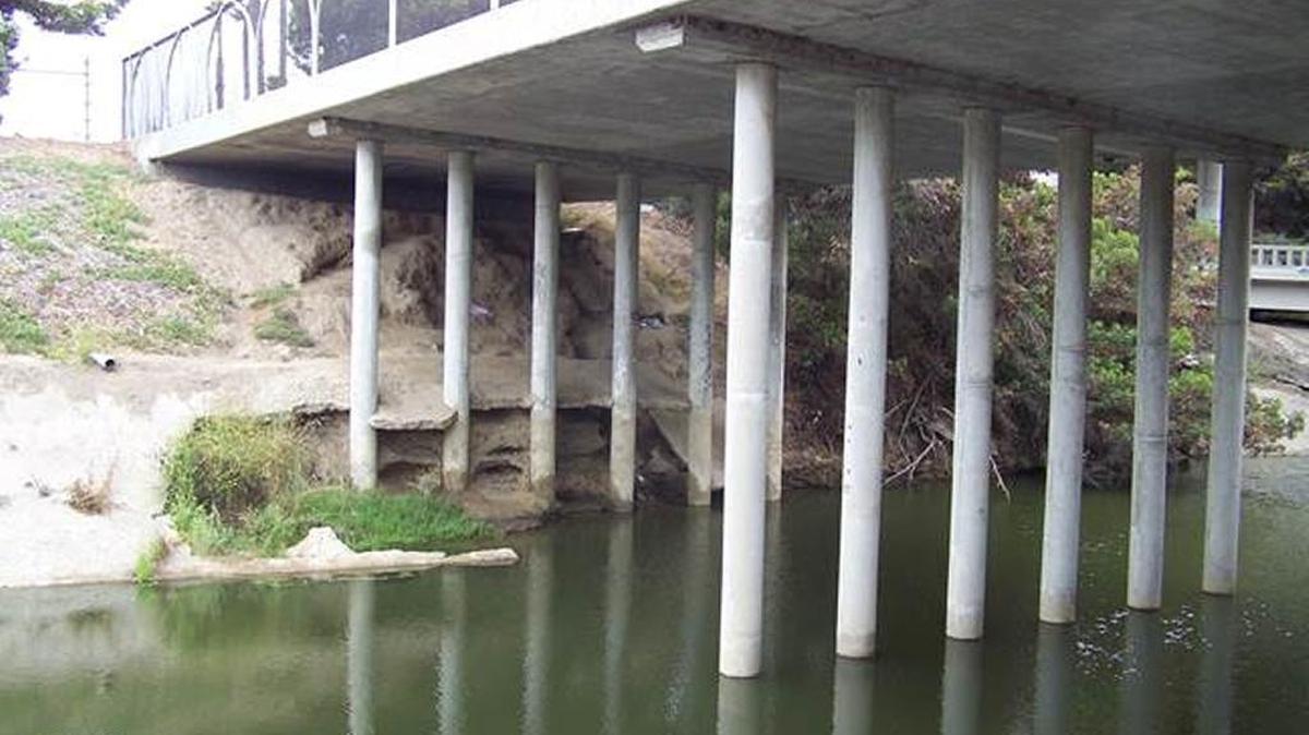 The concrete shoring along the Pismo Creek has worn down over the years, exposing the support columns and threatening the integrity of the bridge and Highway 101 onramp.
