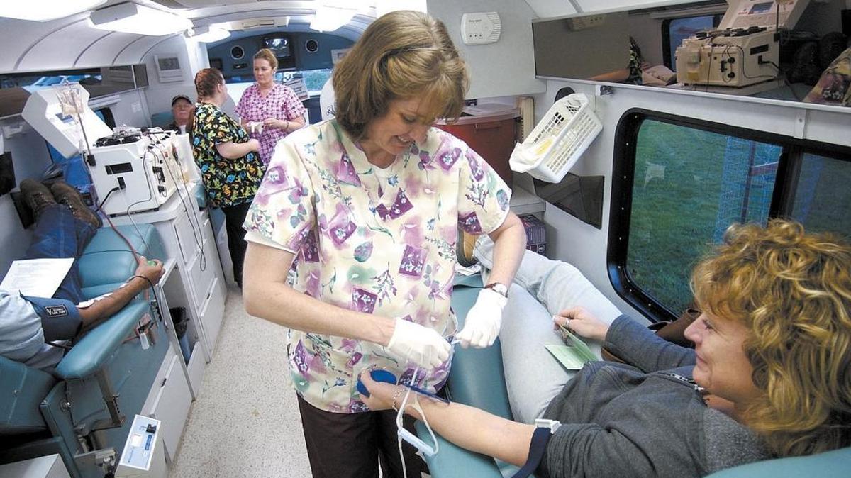 A Phebotomist, Margaret Ginder, left, draws blood from Paulette Scoville, right, during a Tri-Counties blood bank blood drive in Templeton.