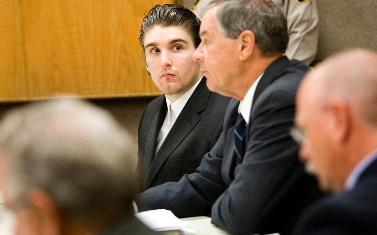 Former Cambria resident Brandon Henslee, left, looks at attorney Fred Foss, during his trial for the murder of half brother Tyler Hanks in 2013.