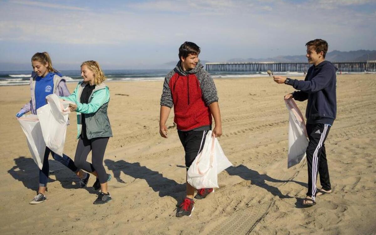 A group from the Church Of Jesus Christ of Latter-Day Saints in Arroyo Grande helps clean up Pismo Beach on Wednesday, July 5, 2017, following Fourth of July festivities on Tuesday.