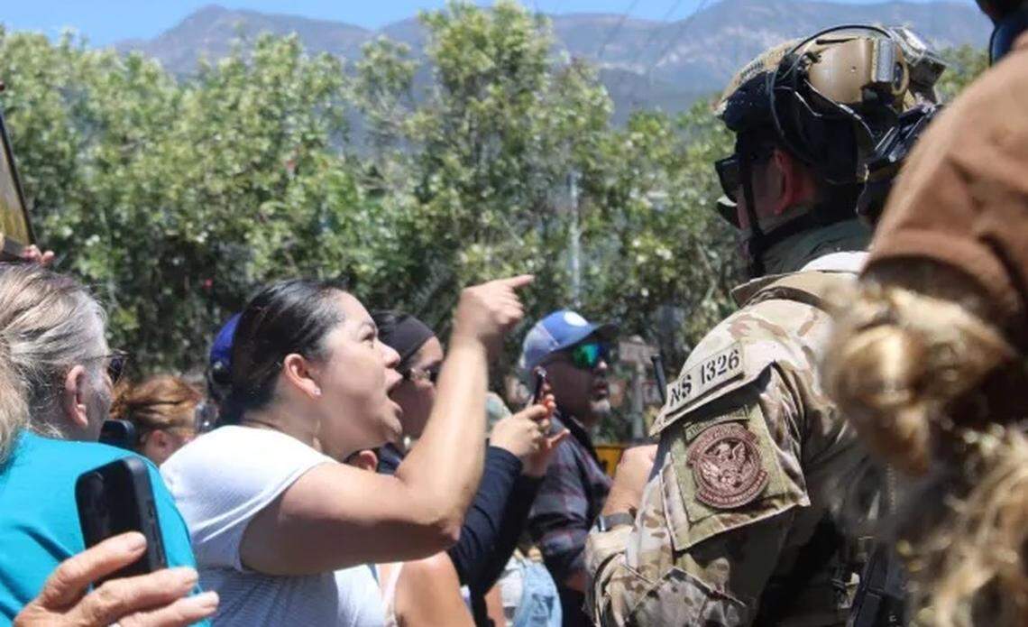 A crowd confronts federal agents conducting an immigration enforcement operation at a Carpinteria cannabis farm Thursday, July 10, 2025. Ten workers were reportedly detained.