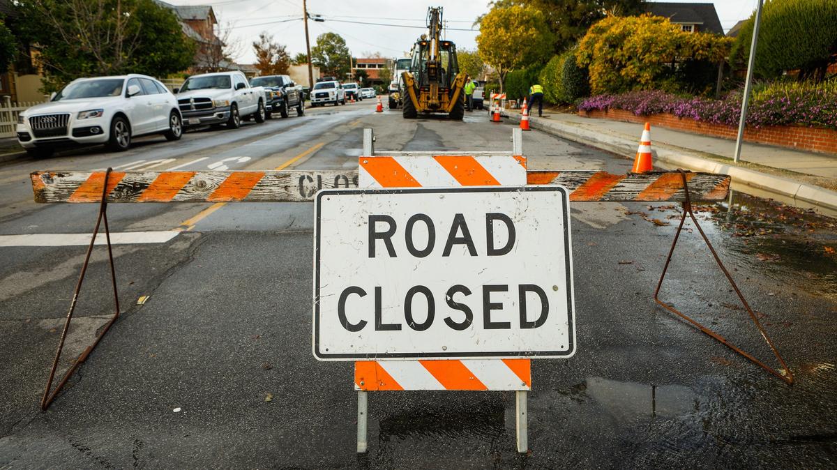 Crews work to repair a water main break at the intersection of Johnson Avenue and Mill Street in San Luis Obispo, which caused traffic delays and water outages on Monday afternoon.