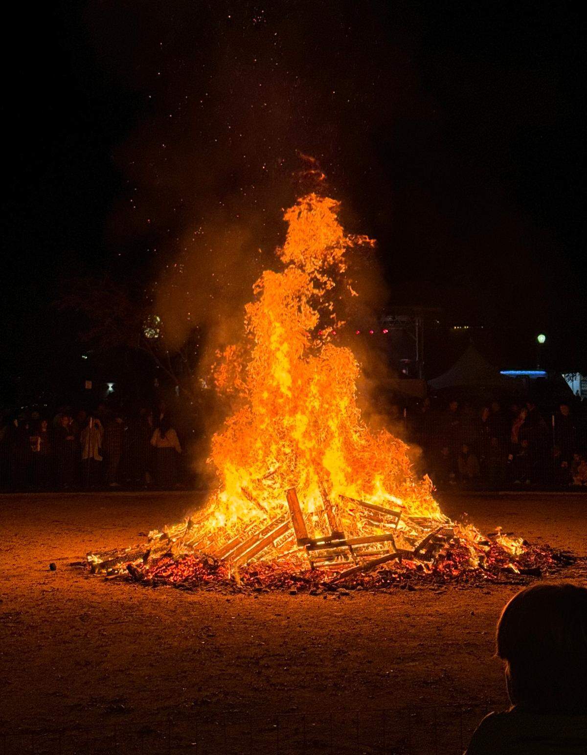 The giant bonfire throws flames into the air at Paso Robles’ New Year’s Eve celebration in the Downtown City Park on Dec. 31, 2023.