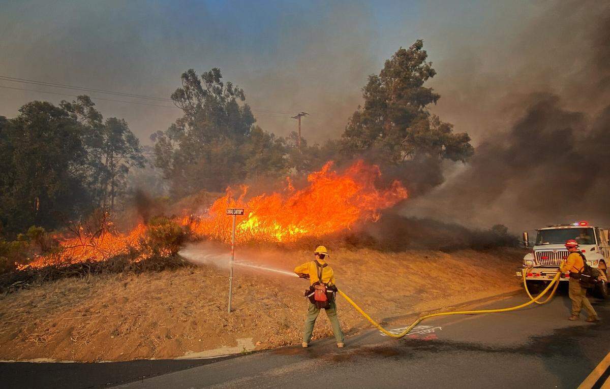 A Santa Barbara County Fire photo posted on Twitter shows firefighters battling the Alisal Fire.