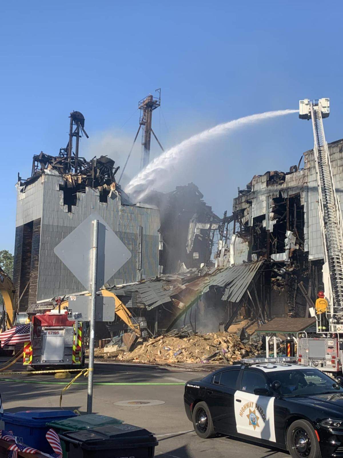Firefighters continue to douse the ruins of the Templeton Feed & Grain building on July 5, 2025, after the historic structure caught fire late on the night of the Fourth of July.