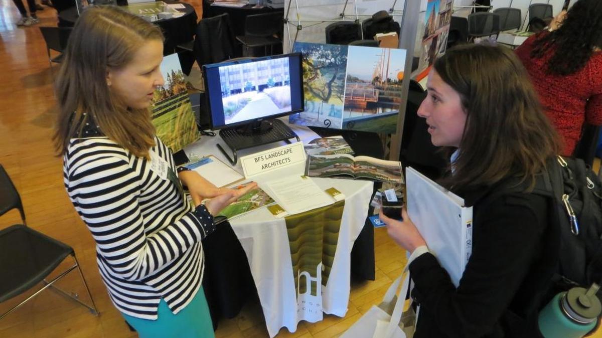 Cal Poly student Holly Hillegass, right, speaks with Elizabeth Matz, a representative from BFS Landscape Architects, located in Monterey and Mountain View, during a recent career fair at the university.