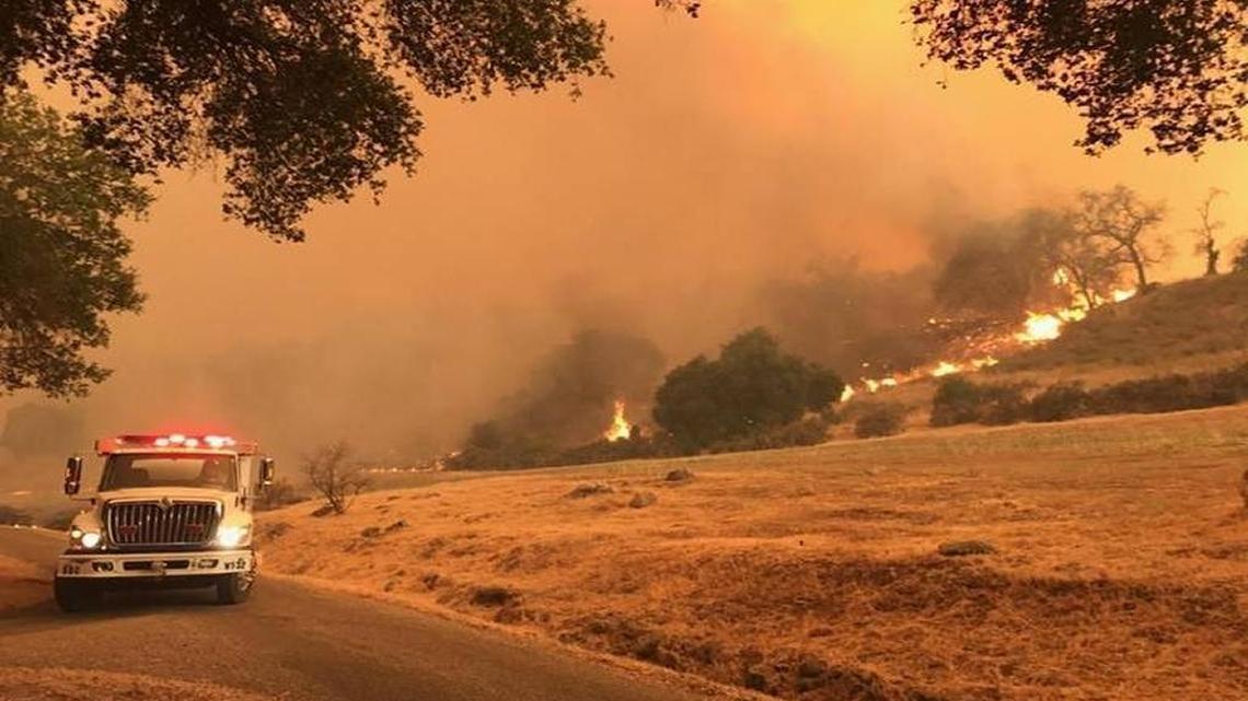 Flames from the Whittier Fire near Lake Cachuma burn toward a ranch on the south side of Highway 154.