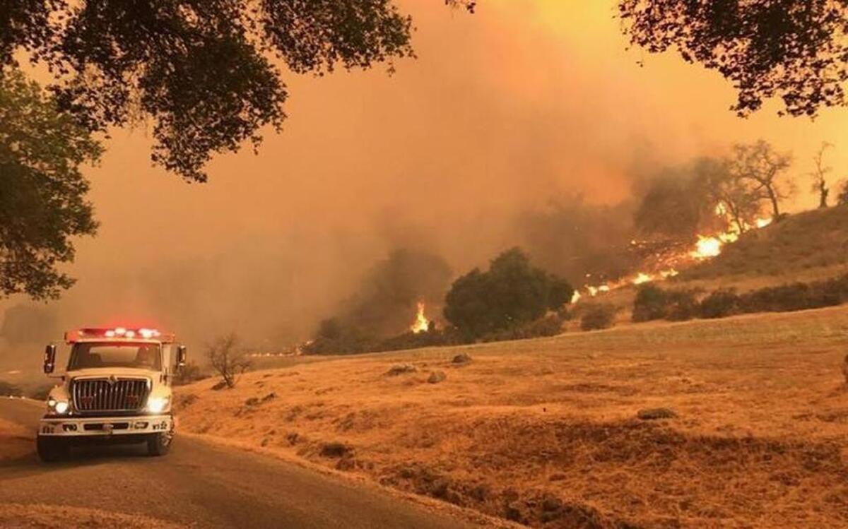 Flames from the Whittier Fire near Lake Cachuma burn toward a ranch on the south side of Highway 154.