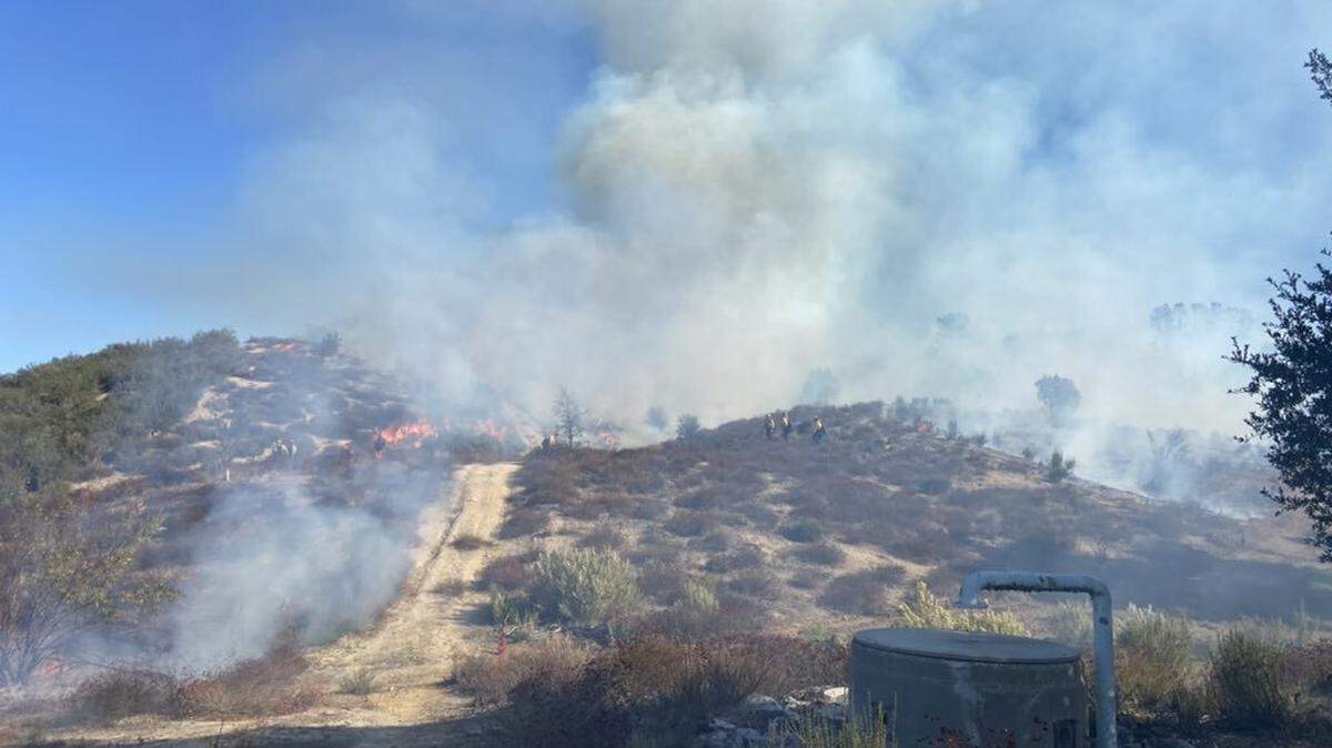 Cal Fire officials conduct a controlled burn near Creston on Wednesday.