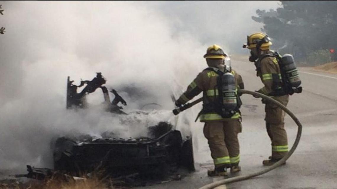 Morro Bay Fire Department firefighters assist Cal Fire with a car fire on Highway 41 on Saturday, July 15, 2017.