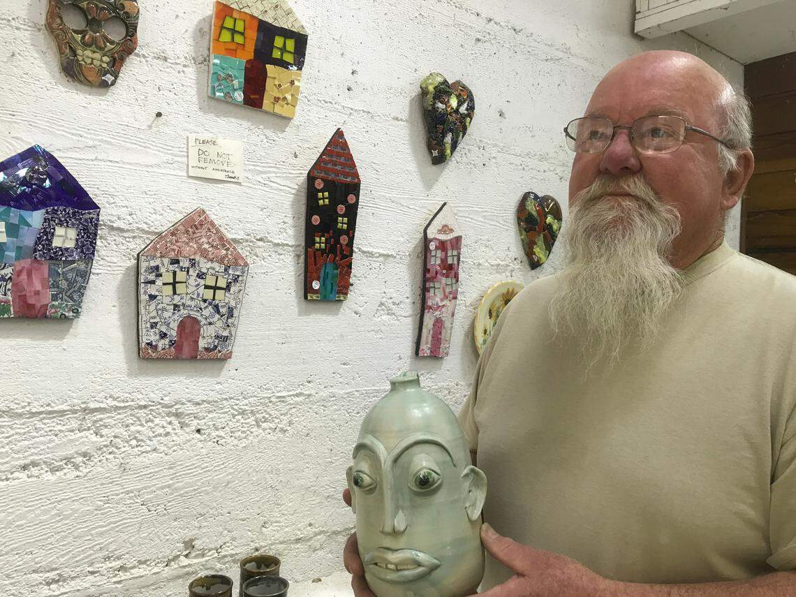 John Schoenstein’s Harmony Pottery Works and studio has been operating in the tiny town since 1973. He and it are still at the shop filled with works by about 150 artists, including Teresa Campbell formerly of Cambria, now of Nashville. Shoenstein is holding and in front of some of Campbell’s artworks.