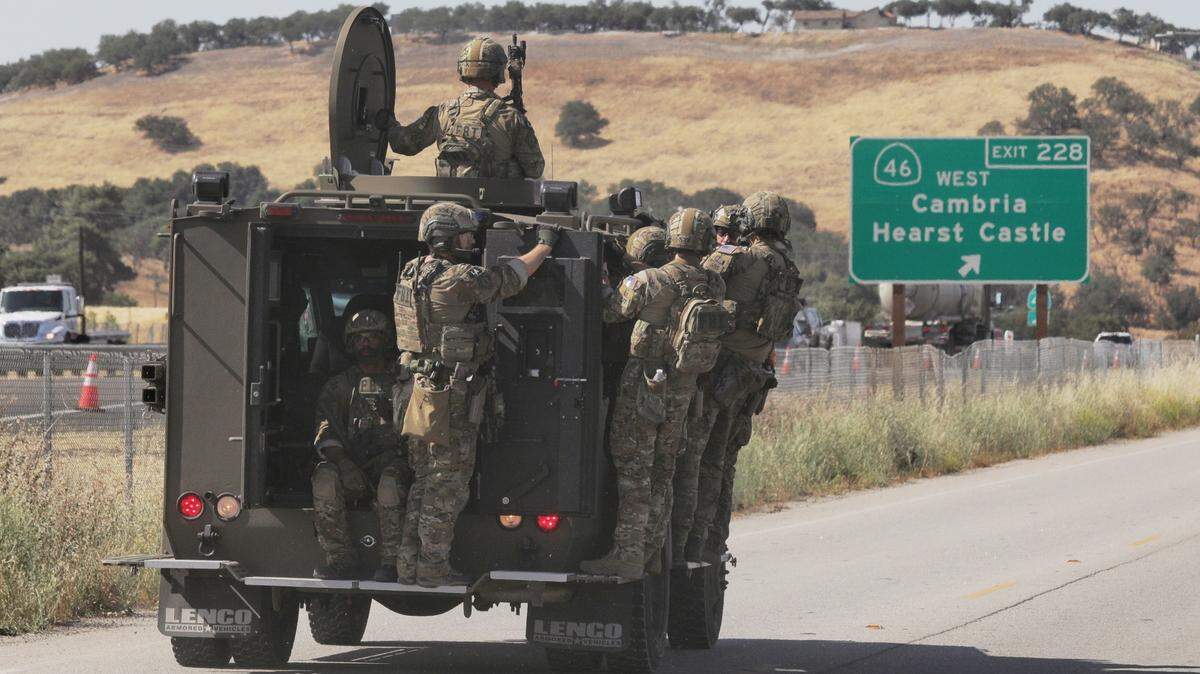 San Luis Obispo County law enforcement officers travel in an armored Bearcat vehicle near Volpi Ysabel Road and Ramada Drive, an industrial area on the south end of Paso Robles in June 2020.