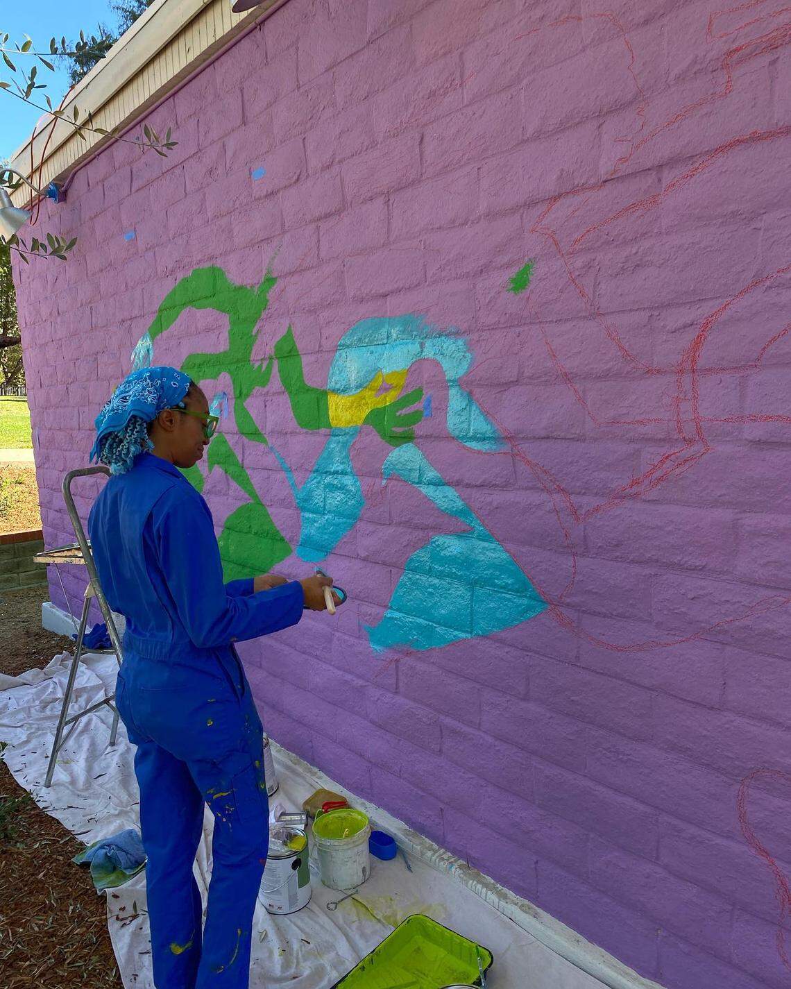 Erin LeAnn Mitchell works on her mural, “Calafia Was Here,” in February at the San Luis Obispo Museum of Art.