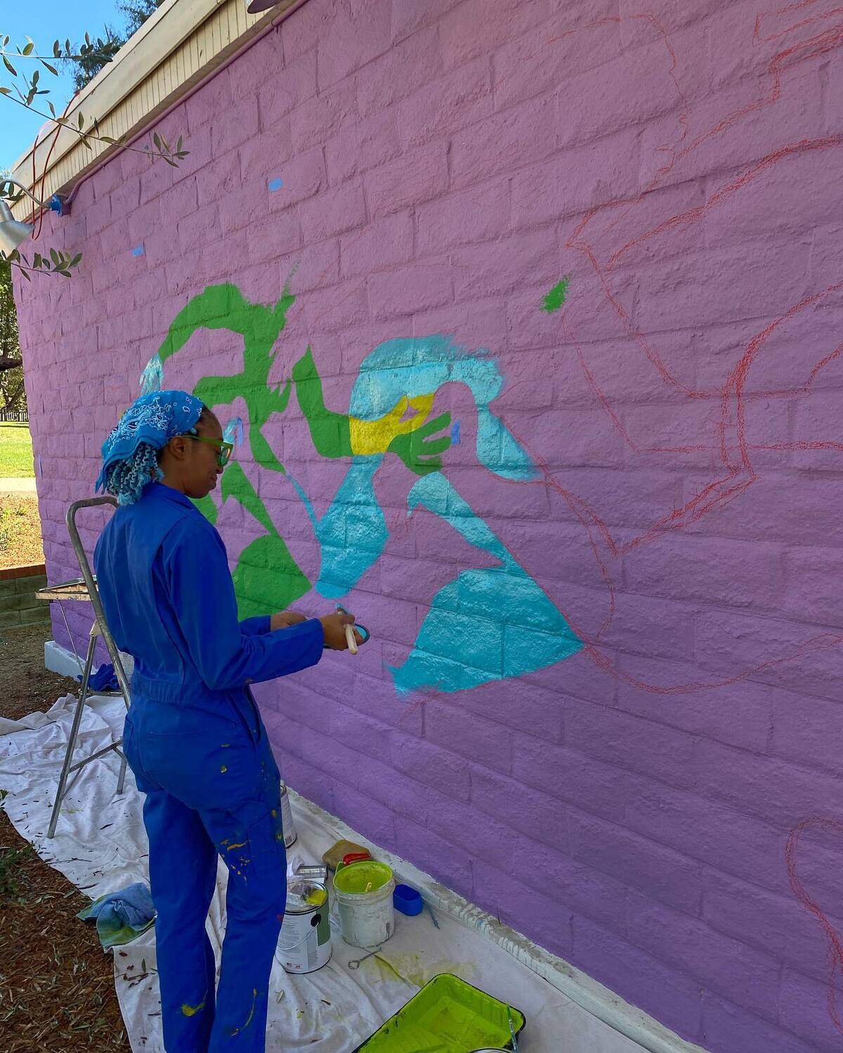 Erin LeAnn Mitchell works on her mural, “Calafia Was Here,” in February at the San Luis Obispo Museum of Art.