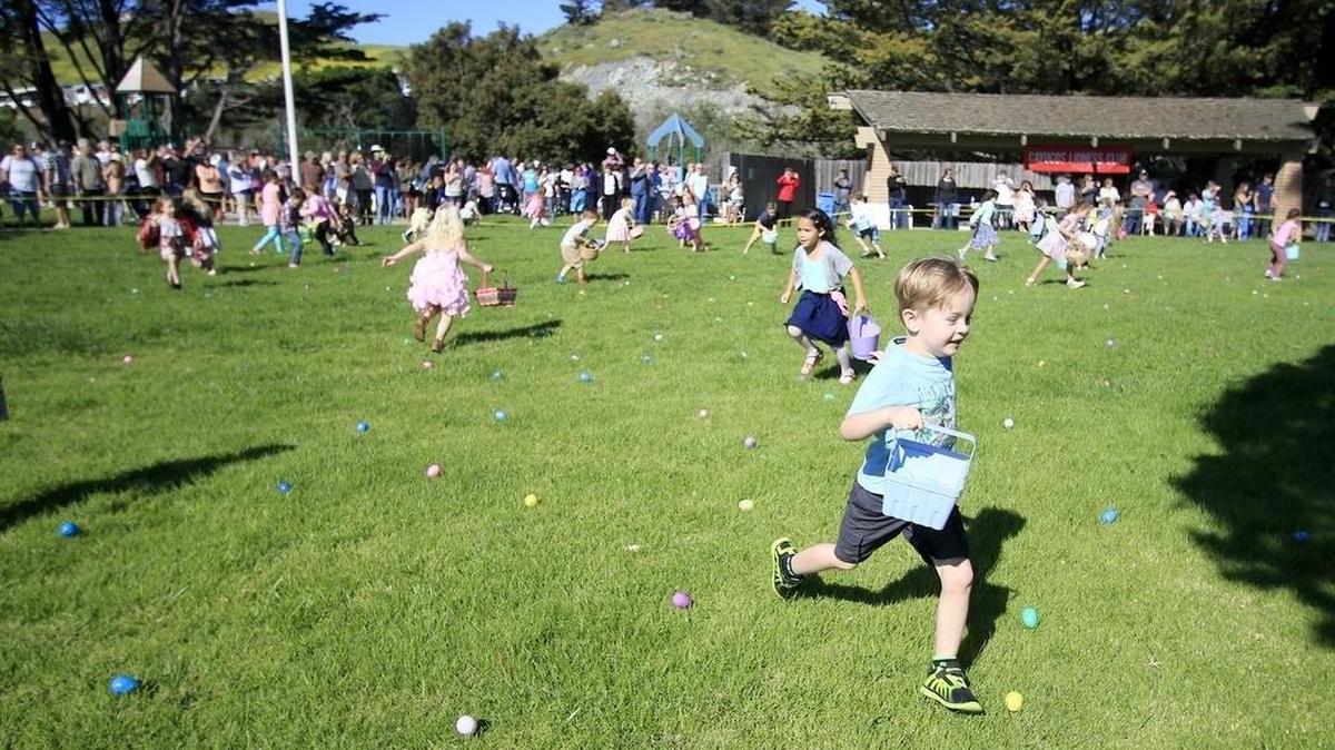 Children run to scoop up around 3,000 goodie-filled plastic eggs at the Cayucos Lioness Club’s annual easter egg hunt at Hardie Park in 2016.