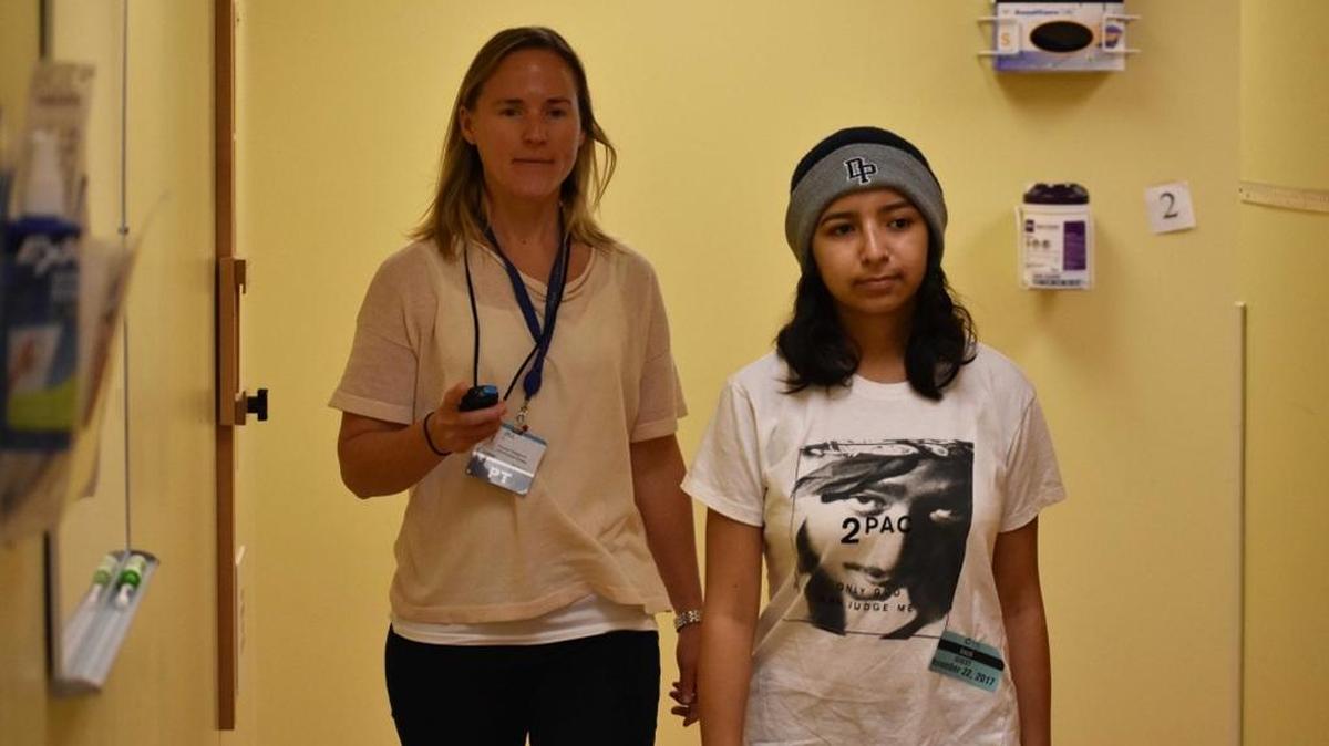 Cottage Rehabilitation Hospital physical therapist Jill Trato times Alyssa Nuño during one of her therapy exercises.