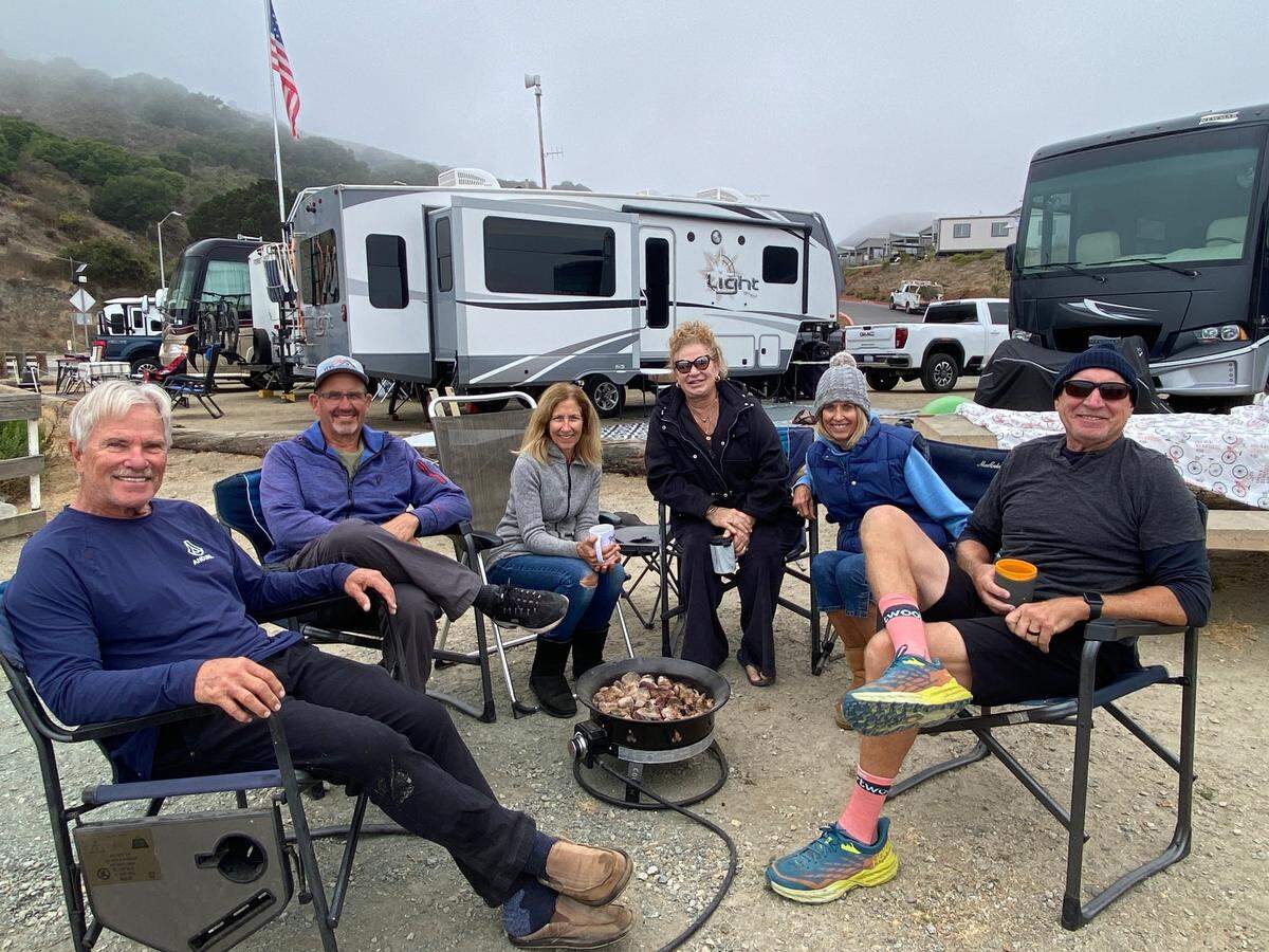 A group of friends enjoy their morning coffee at the Woodyard RV campground in Port San Luis on Oct. 9, 2024. From right to left are Martin Ponek, Margie Couch, Jean Ponek, Gail Farrell, Tom Ferrell and John Couch. The campground is closing in November because the RVs block the view of the ocean.