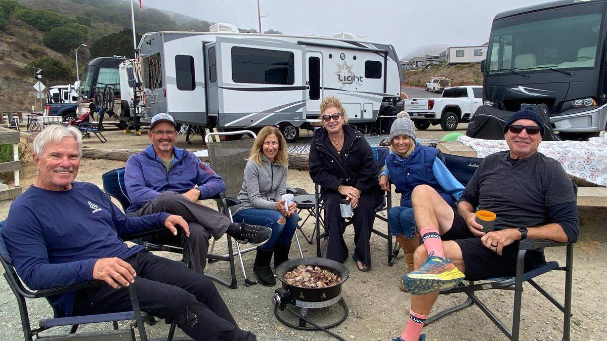 A group of friends enjoy their morning coffee at the Woodyard RV campground in Port San Luis on Oct. 9, 2024. From right to left are Martin Ponek, Margie Couch, Jean Ponek, Gail Farrell, Tom Ferrell and John Couch. The campground is closing in November because the RVs block the view of the ocean.